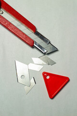 cutter knife with cut blade and tools for cutting with a white background and from a top angle