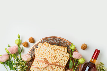 Jewish holiday Passover concept with matzah, seder plate, spring flowers and wine bottle on white  background. Top view, flat lay - 754676219