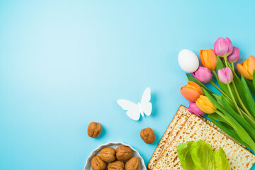Jewish holiday Passover concept with matzah and  spring tulip flowers on blue  background. Top view, flat lay composition - 754676278