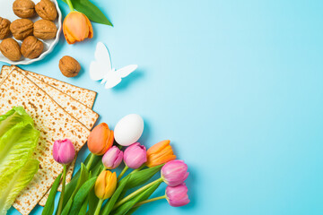 Jewish holiday Passover concept with matzah and  spring tulip flowers on blue  background. Top view, flat lay composition - 754676285