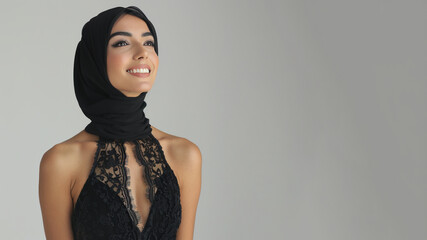 Arab elegant woman in black halter neck dress isolated on gray - obrazy, fototapety, plakaty