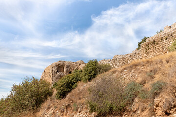 Fototapeta na wymiar Bottom view of hill with ruins of fortress walls and corner tower of medieval fortress of Nimrod - Qalaat al-Subeiba, located near the border with Syria and Lebanon on the Golan Heights, Israel