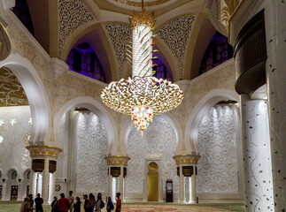 Fototapeta na wymiar The splendor of decorative ornate giant chandeliers made of Swarovski stones in interior of Sheikh Zayed Grand Mosque in Abu Dhabi city, United Arab Emirates