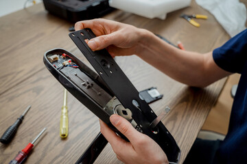 A technician assembles and installs smart electronic door lock for house protection