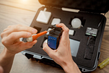 A technician works with a demo kit of the smart home system