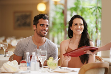 Couple, restaurant and menu with dinner, romance and love for anniversary or celebration. Woman,...