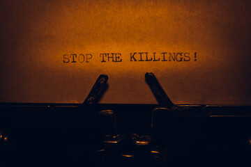 STOP THE KILLINGS typed words on a vintage typewriter. Close up. Antique Typewriter.