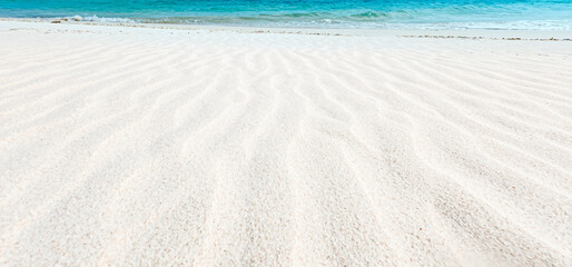 Ripples of  white sand  with beach wave background