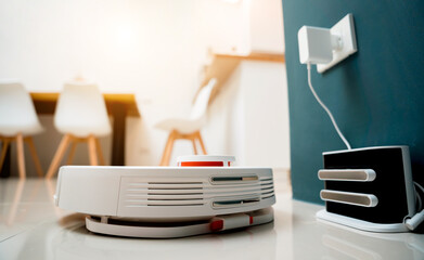 A robot vacuum cleaner at home moving towards the charging station.