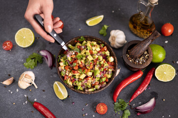 traditional salsa dip snack in wooden bowl on a table with ingredients