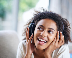 Headphones, smile and happy woman person on couch, living room and listening to music. Happy,...