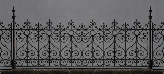 wrought iron fence in Victorian style. Seamless decorative element. An artistic vintage fence with...