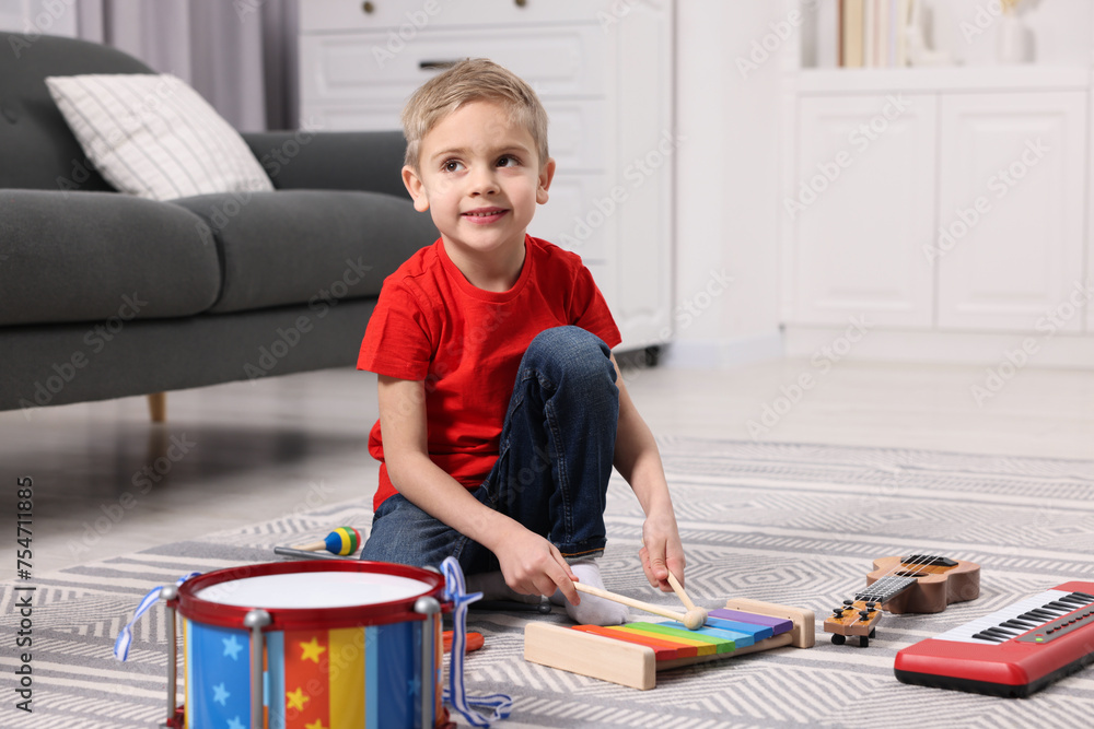 Canvas Prints Little boy playing toy xylophone at home