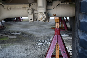 Rear axle on military vehicle, jacked up.