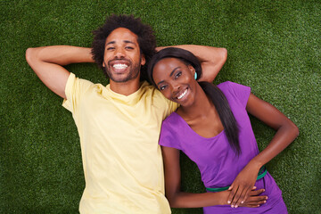 Couple, portrait and top view with smile on grass for bonding, support and outdoor date in garden...