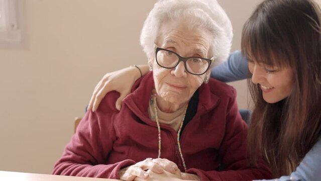 Granddaughter cheers up her sad grandmother in a nursing home