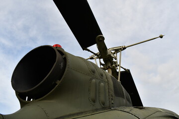 Turbine engine exhaust on rear of old vintage helicopter.
