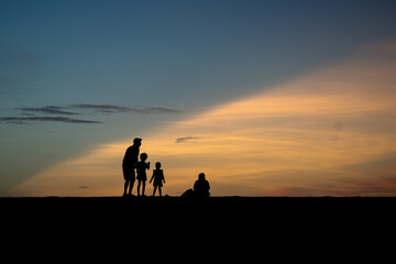 silhouette of one family  on the beach