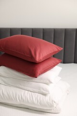 Soft pillows and duvet on bed at home