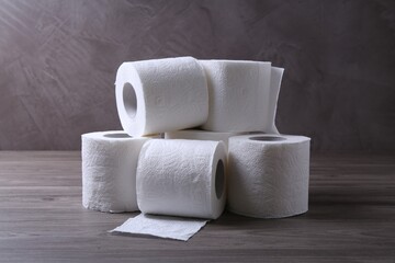 Soft toilet paper rolls on wooden table