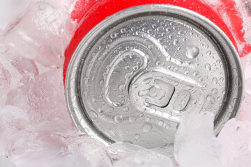 Energy drink in wet can and ice cubes, closeup