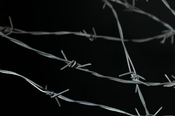 Metal barbed wire on black background, closeup