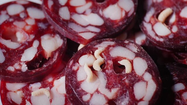 Rotten sausage, maggots crawl ingest