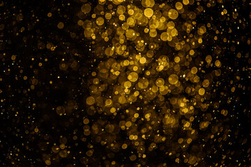 Blurred photo with golden dots visible glittering, shining brightly look and feel luxurious