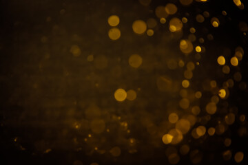 Blurred photo with golden dots visible glittering, shining brightly look and feel luxurious Suitable for use as a wallpaper