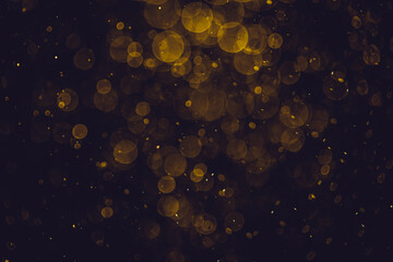 Blurred photo with golden dots visible glittering, shining brightly look and feel luxurious