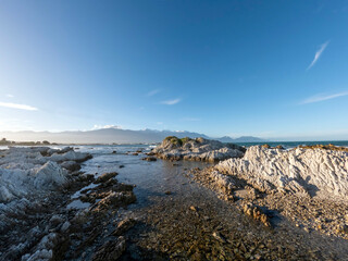 Golden Sunset Serenity: Kaikoura Coastal Walkway Landscape with clifftop views of the sea and...