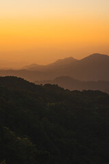 nature traveling with orange sky and layer of mountain with sunrise background