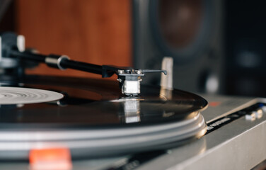 Close-up of a cartridge head on a vinyl record, analog retro music, vinyl disc collecting, vintage equipment