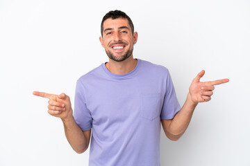 Young handsome caucasian man isolated on white background pointing finger to the laterals and happy