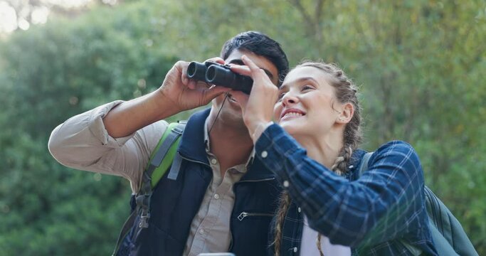 Forest, excited and adventure for couple with binoculars for watching in woods, phone and journey. Location, man and woman in relationship on date for travel in nature with mobile and technology