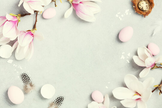 beautiful spring magnolia flowers and Easter decoration on grey stone background, space for text