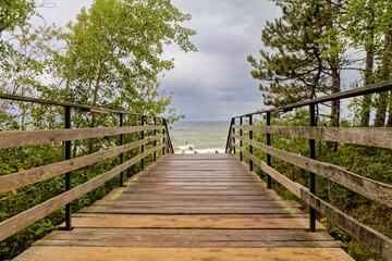 Wooden pier as an entrance to the beach