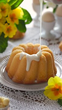 Bundt cake, Babka covered with icing, vertical. Traditional Easter bundt cake