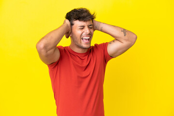 Fototapeta na wymiar Young caucasian handsome man isolated on yellow background stressed overwhelmed