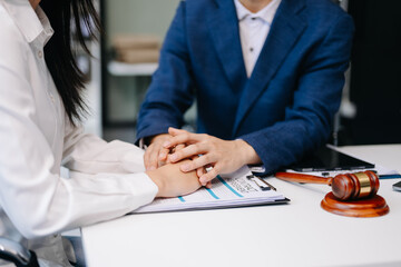 Judge gavel with scales of justice, Business and lawyer or counselor consulting and discussing contract papers with laptop and tablet at law firm .