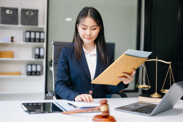 Asian woman lawyer working and gavel, tablet, laptop in front, Advice justice and law concept..