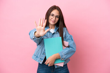 Fototapeta premium Young Ukrainian student woman isolated on pink background counting five with fingers