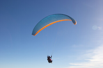 Paragliding. Paragliding in Auvergne. paragliding flight in the mountains in France. Paragliding over the clouds. Sea of clouds and paraglider. Panorama of the mountains. Puy de D&ocirc;me. Parapente.