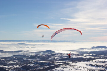 Two paragliders. Paragliding in Auvergne. paragliding flight in the mountains in France....