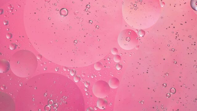 Abstract pink colorful background with oil on water surface. Oil drops in water abstract psychedelic, abstract image.
