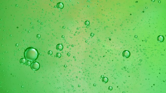 Abstract green colorful background with oil on water surface. Oil drops in water abstract psychedelic, abstract image.