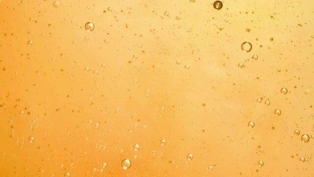 Abstract yellow colorful background with oil on water surface. Oil drops in water abstract psychedelic, abstract image.