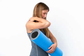 Young sport woman going to yoga classes while holding a mat suffering from pain in shoulder for...