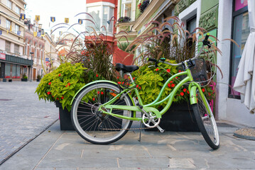 Fototapeta na wymiar Slovenia, Celje. Green bicycle on the street of the old town.