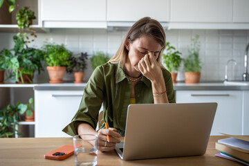 Overworked female freelancer having headache, stress, fatigue, nervous overload of hard job,...